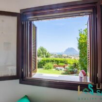 view from a window of tavolara island and the coastline