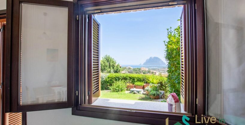 view from a window of tavolara island and the coastline